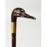 A VICTORIAN CARVED DUCK'S HEAD WALKING STICK, maker J. H. with two gilt bands, originally an