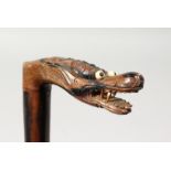 A CHINESE CARVED DRAGON HANDLE WALKING STICK. 34ins long.