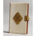 AN IVORY AND GILT MOUNTED PRAYER BOOK. 3.75ins x 2.5ins.