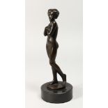 A GOOD BRONZE STANDING NUDE OF A YOUNG GIRL on a circular marble base. 10ins high.