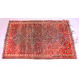 A PESIAN TEKKE DESIGN RUG, red ground with four large central diamond shaped medallions. 5ft 10ins x