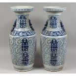 A PAIR OF CHINESE BLUE AND WHITE VASES. 23ins high.