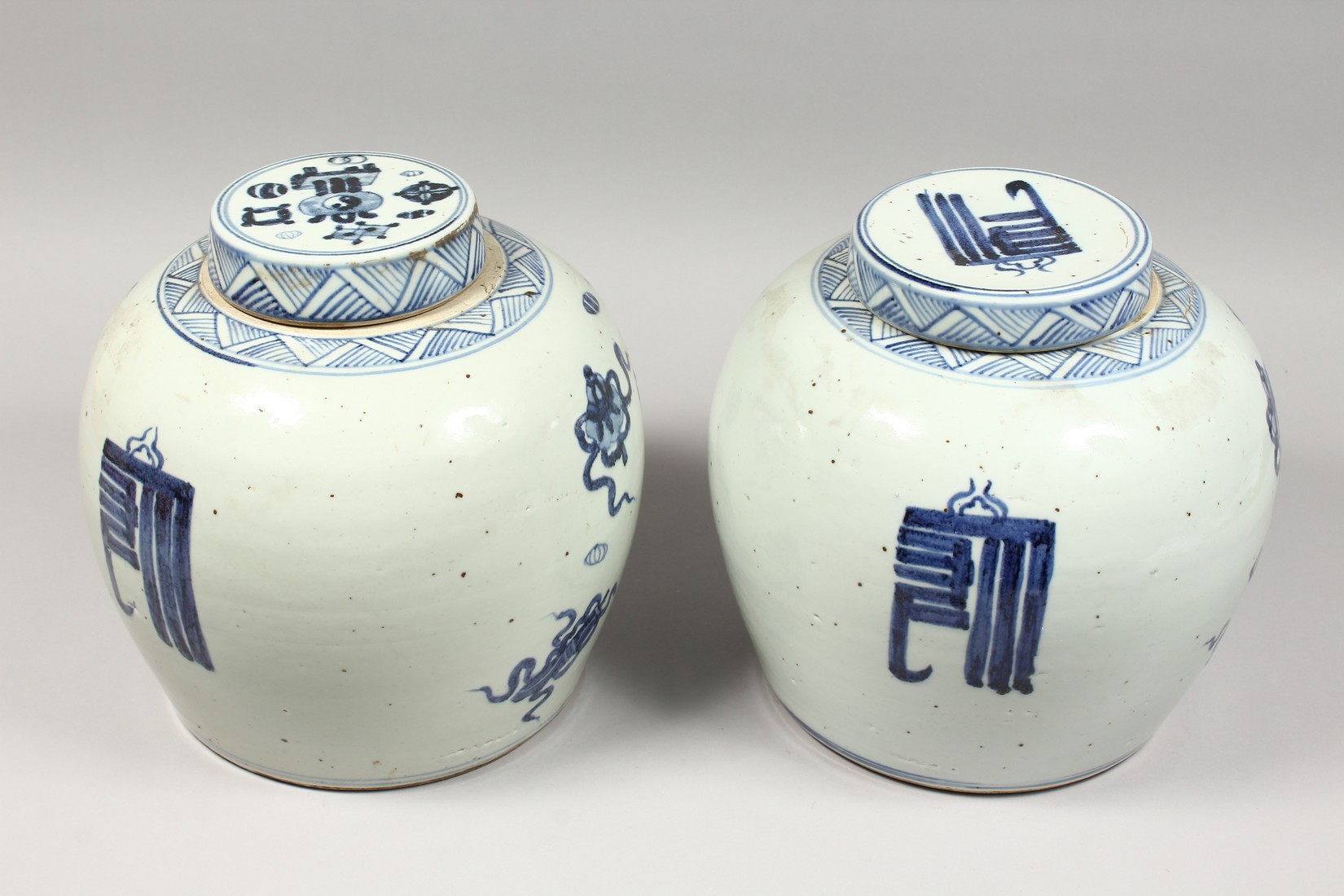 A PAIR OF CHINESE BLUE AND WHITE GINGER JARS AND COVERS. 11ins high. - Image 3 of 3