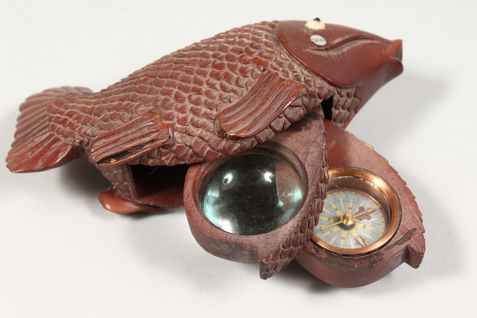 AN UNUSUAL CARVED WOOD CARP with a magnifying glass and compass. 5ins long. - Image 4 of 4