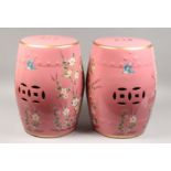 A PAIR OF PINK CHINESE PORCELAIN BARREL SEATS with flowers and birds. 17.5ins high.