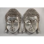 A PAIR OF SILVER WALL BUDDHAS. 22ins long.
