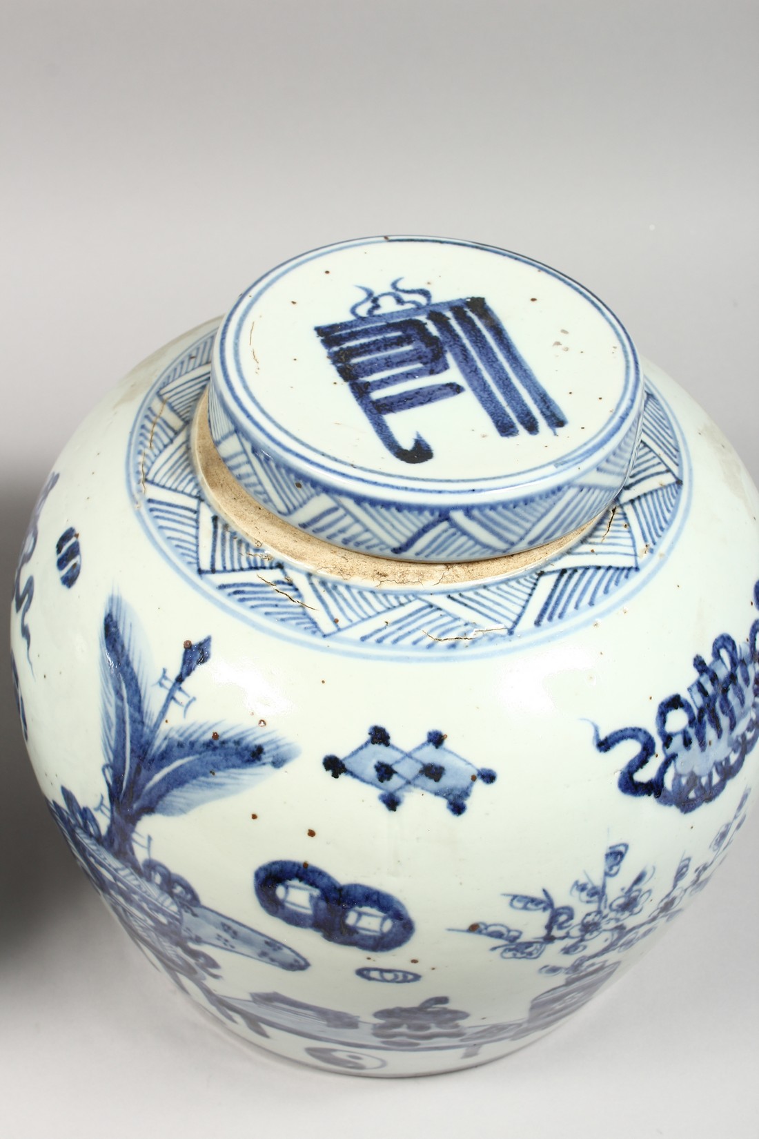 A PAIR OF CHINESE BLUE AND WHITE GINGER JARS AND COVERS. 11ins high. - Image 2 of 3