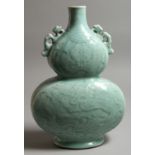 A CHINESE LIGHT BLUE DOUBLE GOURD VASE. Monogrammed in blue. 13ins high.