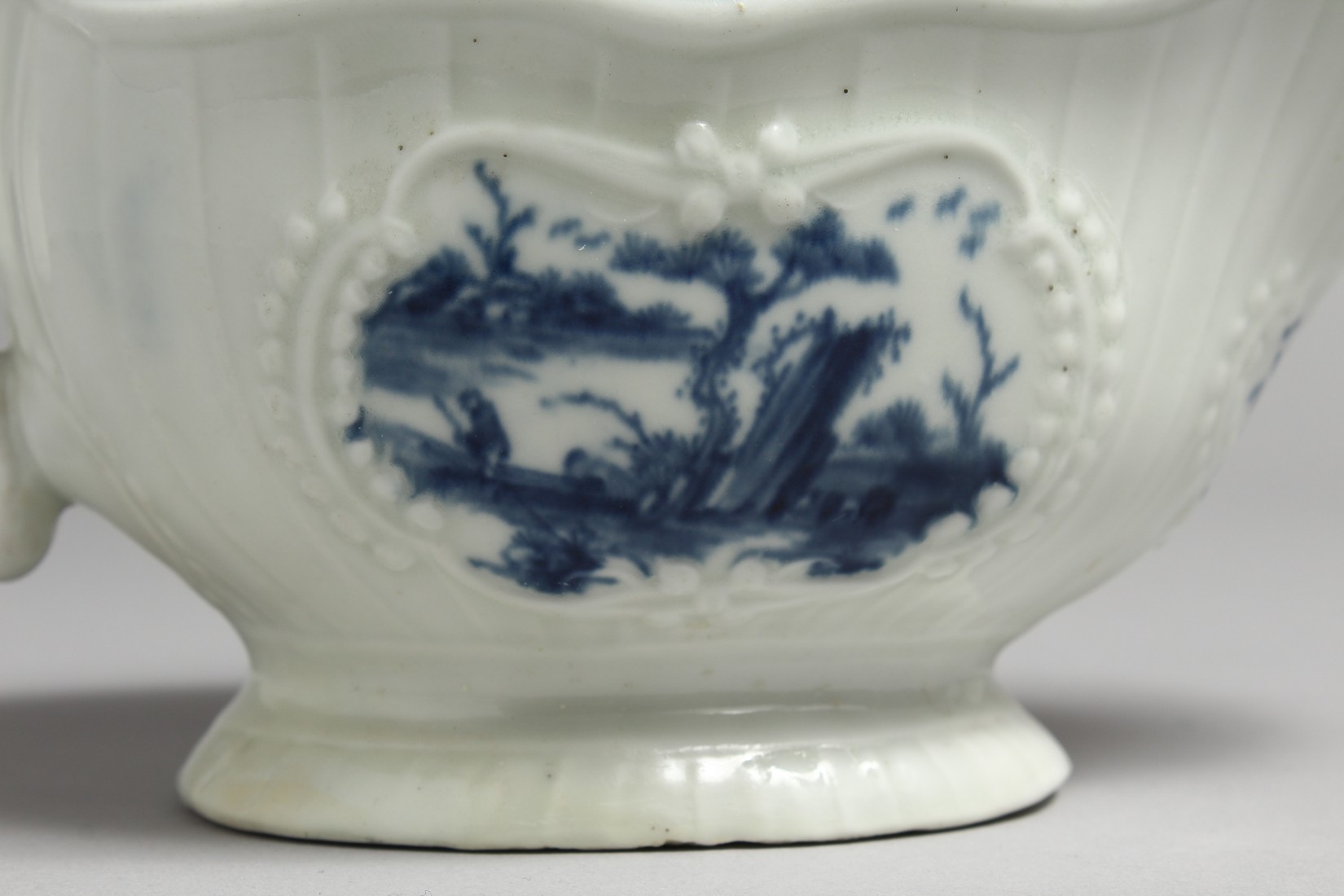 AN 18TH CENTURY WORCESTER SAUCEBOAT, with strap moulded body painted with Chinoiserie landscapes - Image 2 of 11