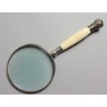 A LARGE IVORY SILVER MOUNTED MAGNIFYING GLASS.