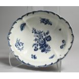 AN 18TH CENTURY DISH OF VERY RARE SHAPE, with feather-like moulded border decorated with flowers and