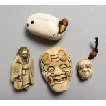 FOUR VARIOUS CARVED IVORY CHINESE NETSUKES, two masks, a figure and a duck.