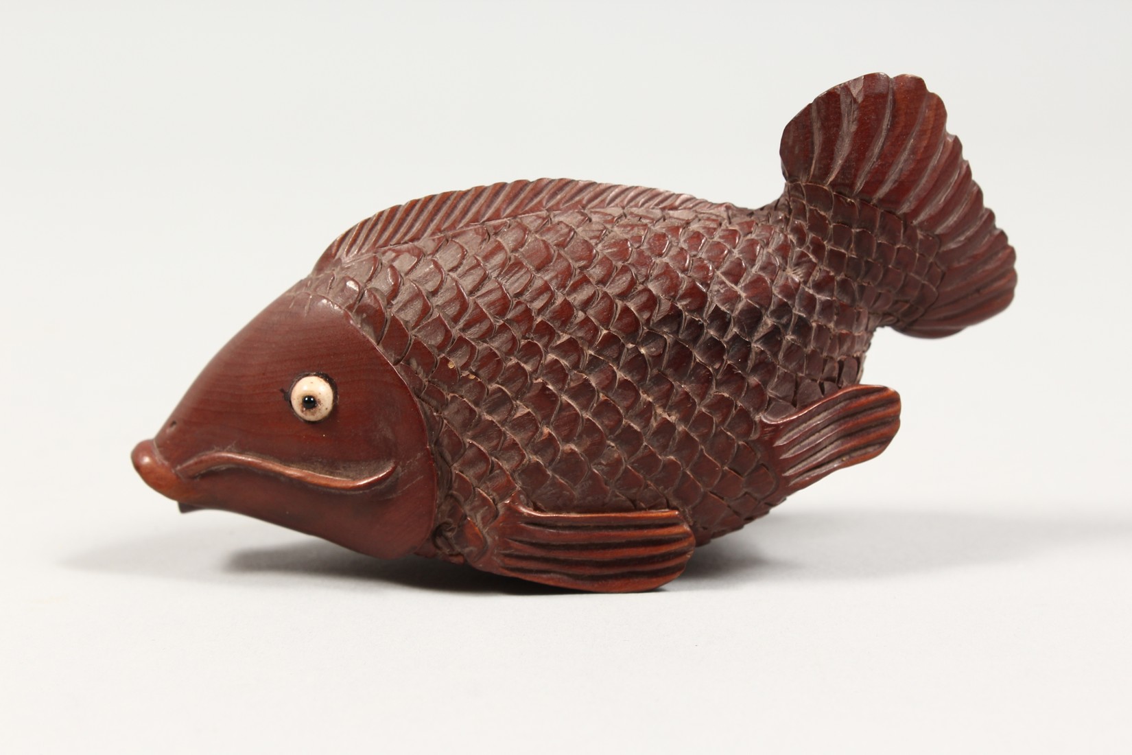 AN UNUSUAL CARVED WOOD CARP with a magnifying glass and compass. 5ins long. - Image 3 of 4