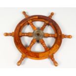 A WOODEN SHIP'S WHEEL. 12ins diameter.