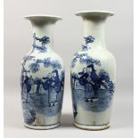 A TALL PAIR OF CHINESE BLUE AND WHITE VASES with figures.