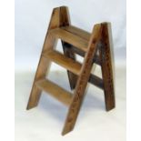 A WOODEN CHAMPAGNE FOLDING LADDER 2ft 8ins.