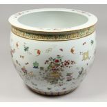 A GOOD CHINESE PORCELAIN JARDINIERE, famille rose with emblems. 15.5ins diameter.