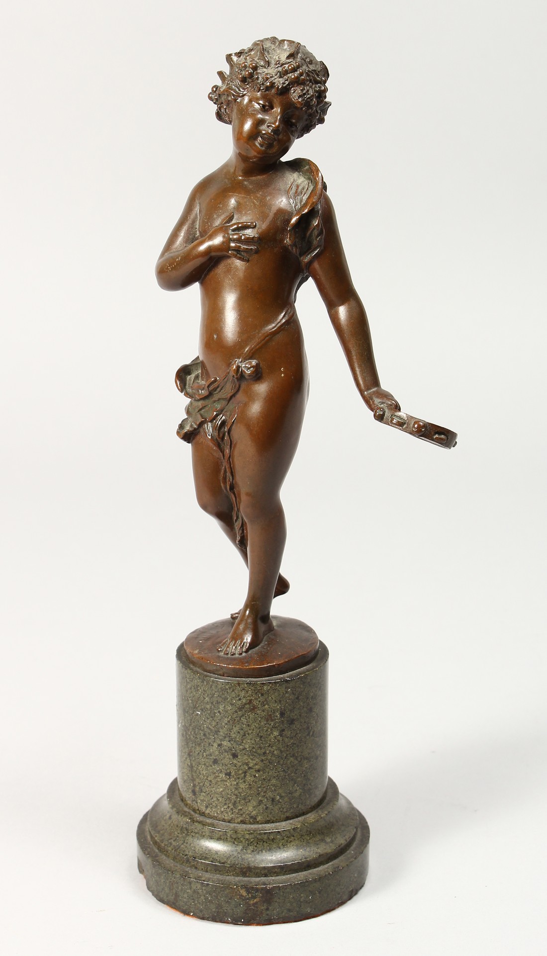 A GOOD BRONZE SEMI NAKED YOUNG GIRL holding a tambourine. Signed, on a marble base.