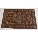 A PERSIAN ISFAHAN RUG, red and blue ground with allover floral decoration. 7ft 5ins x 4ft 8ins.
