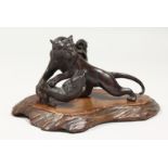 JAPANESE BRONZE TIGERS on a wooden base. 8ins long.