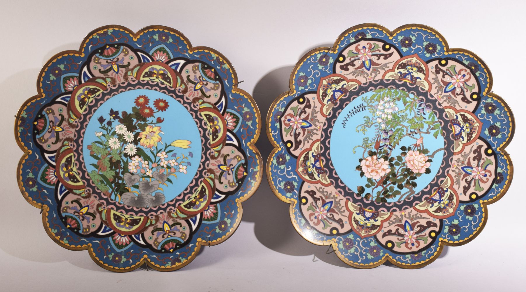 A PAIR OF JAPANESE FLOWER SHAPED CLOISONNE DISHES, decorated with native flora, stylised floral