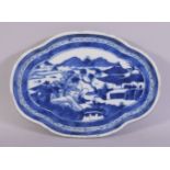 A CHINESE BLUE AND WHITE PORCELAIN DISH, the centre painted with a mountainous landscape with