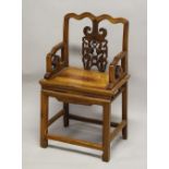 A CHINESE PIERCED AND CARVED WOODEN CHAIR, with shaped top rail and carved back section with a bat