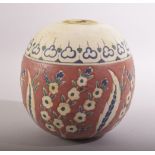 A TURKISH IZNIK POTTERY MOSQUE BALL, decorated with stylised flora, 14cm high.
