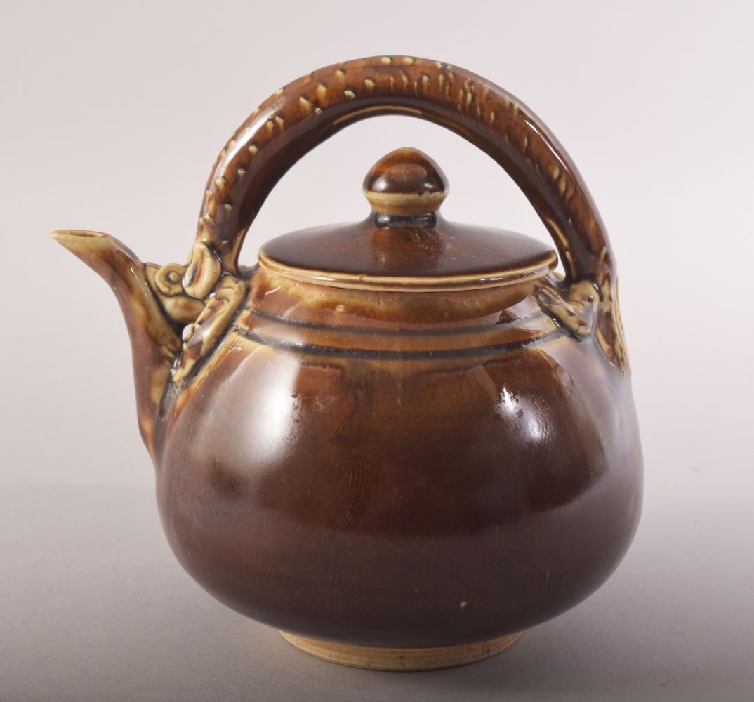 A SMALL CHINESE TREACLE GLAZE TEAPOT, with a chilong type handle, 13.5cm high.