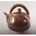 A SMALL CHINESE TREACLE GLAZE TEAPOT, with a chilong type handle, 13.5cm high.