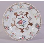 A CHINESE FAMILLE ROSE PORCELAIN PLATE, decorated with flowers and stylised floral motifs, 23cm