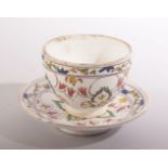 A TURKISH KUTAHYA CUP AND SAUCER, with decorative foliate design, cup 9cm diameter, saucer 13,5cm