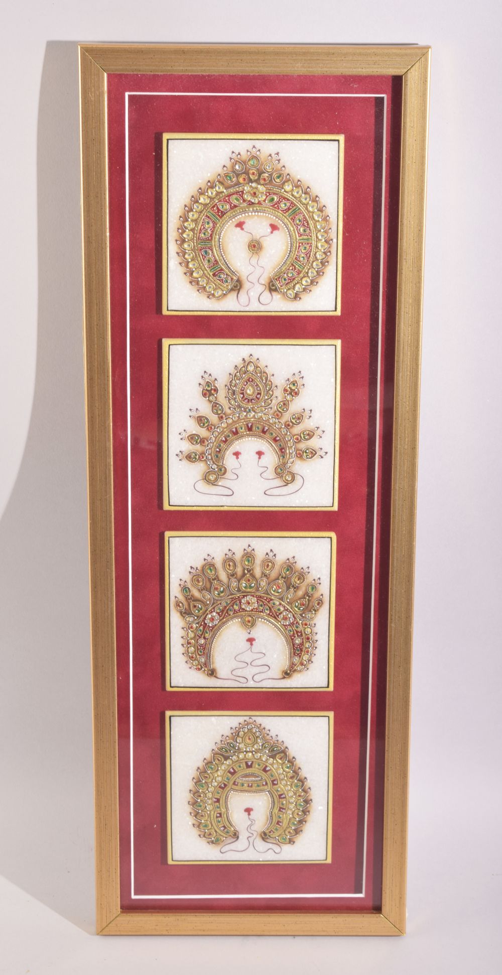 A SET OF FOUR TANJORE RAJASTHAN PAINTED MARBLE TILES, painted in gold and overlaid with semi-