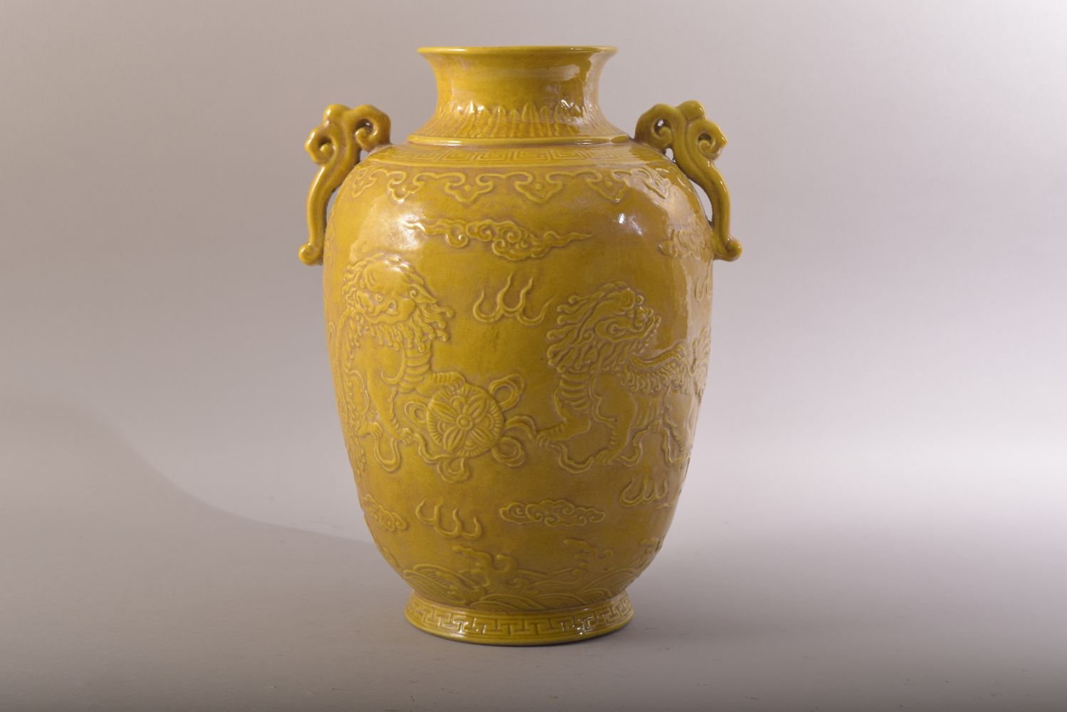 A CHINESE YELLOW GLAZED PORCELAIN TWIN HANDLE JAR - decorated in relief with two lion dogs amongst - Image 3 of 7