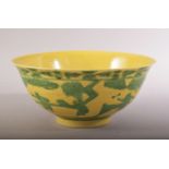 A CHINESE YELLOW GROUND PORCELAIN BOWL, with incised and green highlighted decoration depicting boys
