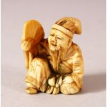 A JAPANESE MEIJI PERIOD CARVED IVORY NETSUKE - SEATED MAN - carved depicting a seated scholar or
