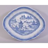 A CHINESE BLUE AND WHITE PORCELAIN DISH, the centre painted with a landscape scene, 26.5cm x 22cm.