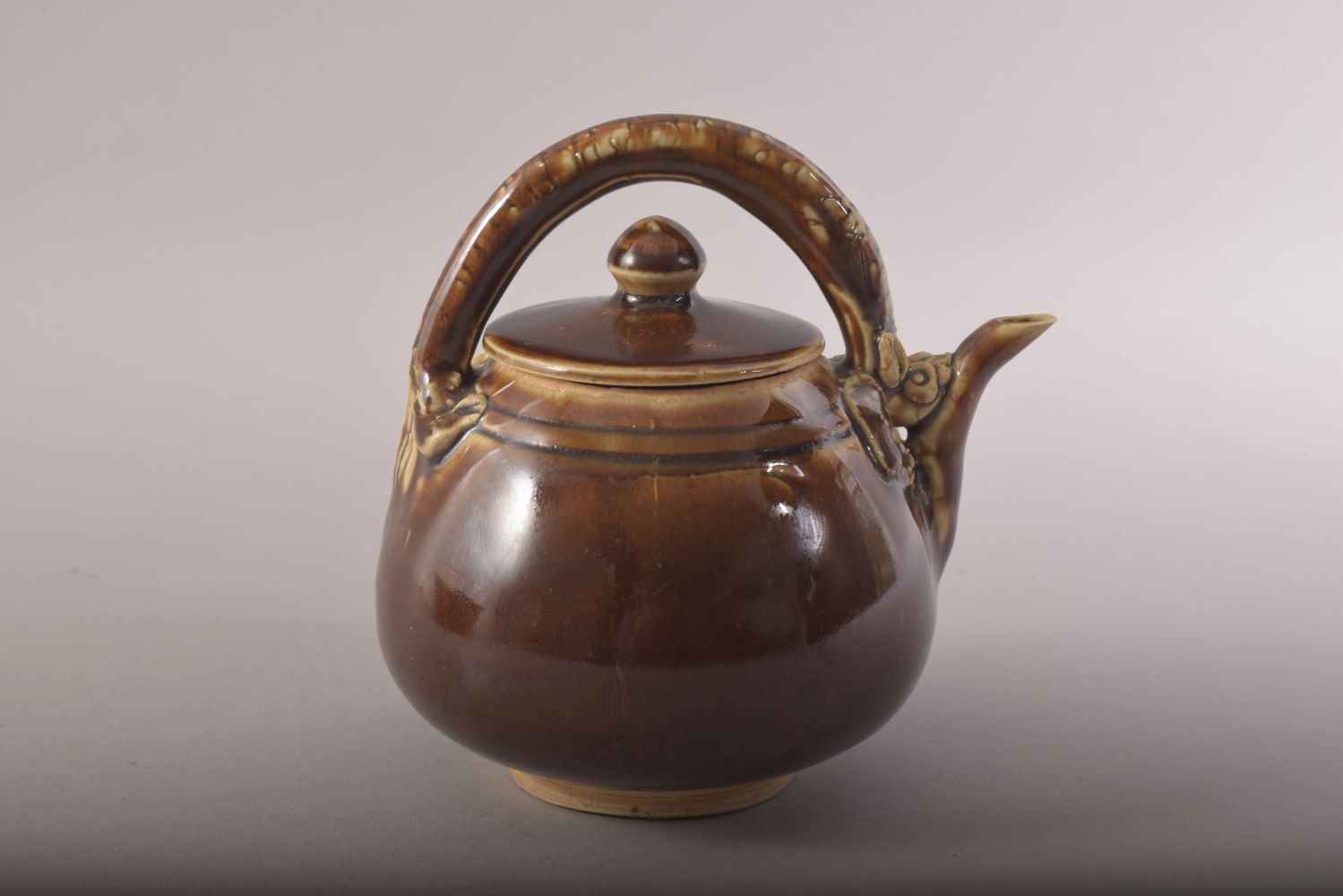 A SMALL CHINESE TREACLE GLAZE TEAPOT, with a chilong type handle, 13.5cm high. - Image 3 of 8