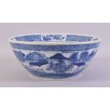 A LARGE CHINESE BLUE AND WHITE PORCELAIN BOWL, decorated with a landscape including figures,