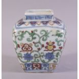 A CHINESE MING STYLE SQUARE FORM DOUCAI JAR, painted with precious objects and scrolling vines,