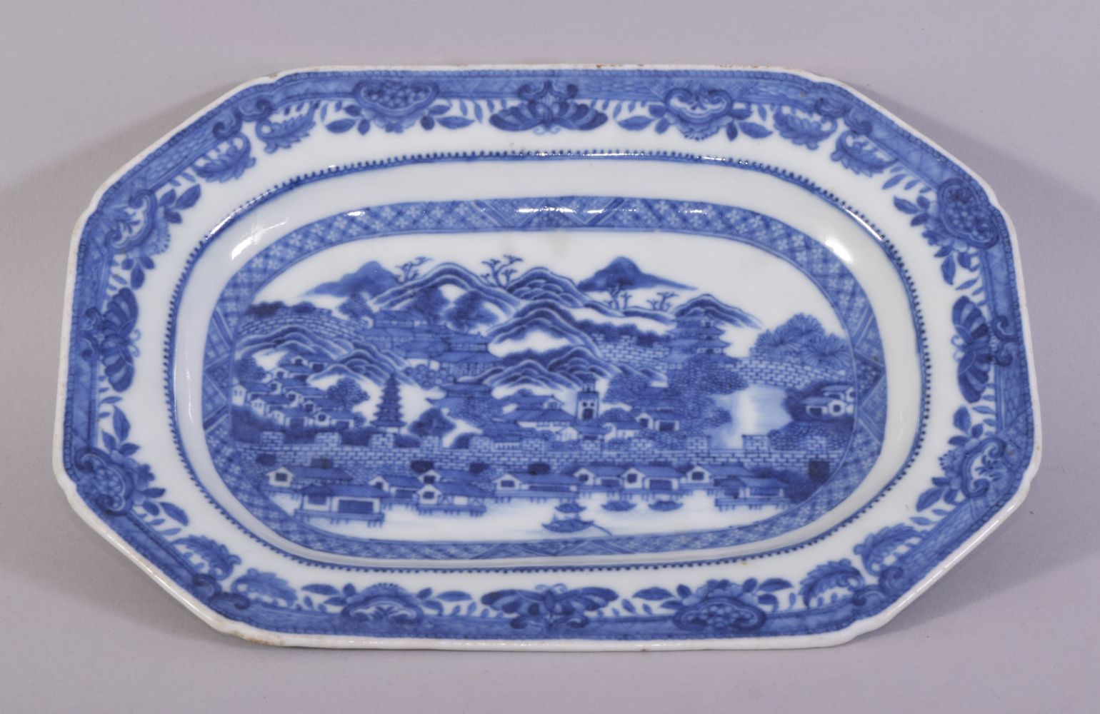 A CHINESE BLUE AND WHITE RECTANGULAR PORCELAIN DISH, the centre painted with a mountainous landscape