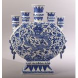 A CHINESE BLUE AND WHITE FLOWER VASE, with multi spouts / openings, the vase painted with a dragon