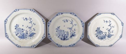 THREE LARGE CHINESE BLUE AND WHITE OCTAGONAL PORCELAIN PLATES, each painted with native flora, (AF),