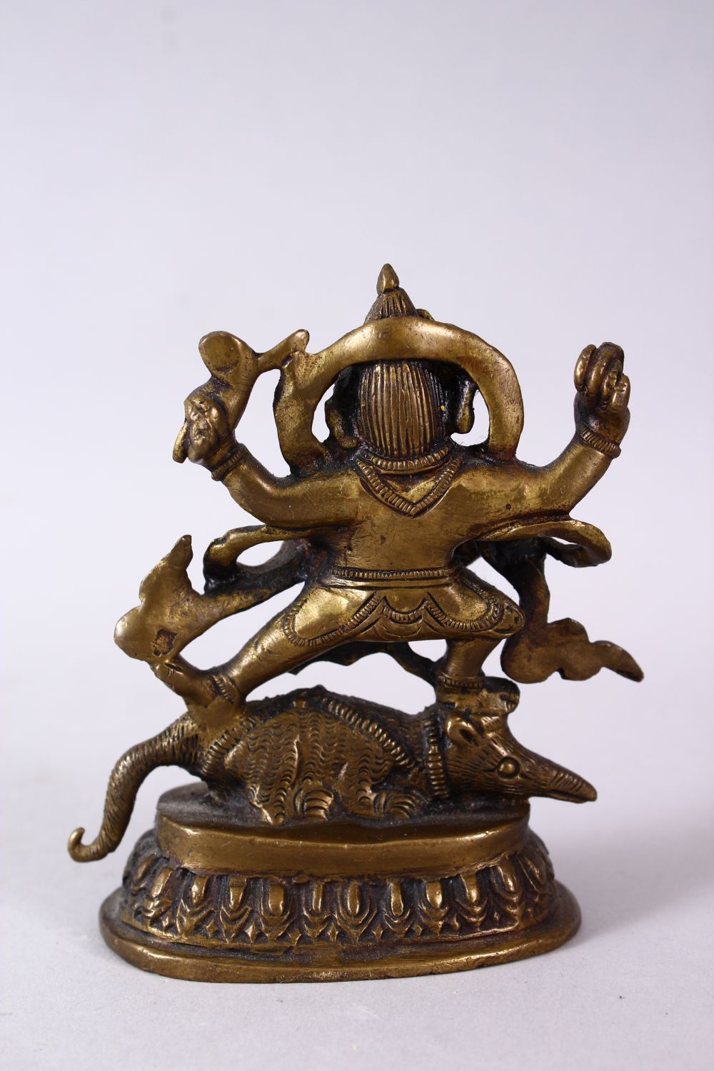 A SMALL INDIAN BRONZE FIGURE OF GANESH UPON BEAST, upon a stylized base, holding many implements. - Image 4 of 6