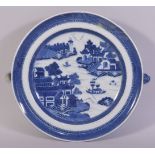 A CHINESE BLUE AND WHITE PORCELAIN WARMING DISH, painted with a landscape scene, 24.5cm.