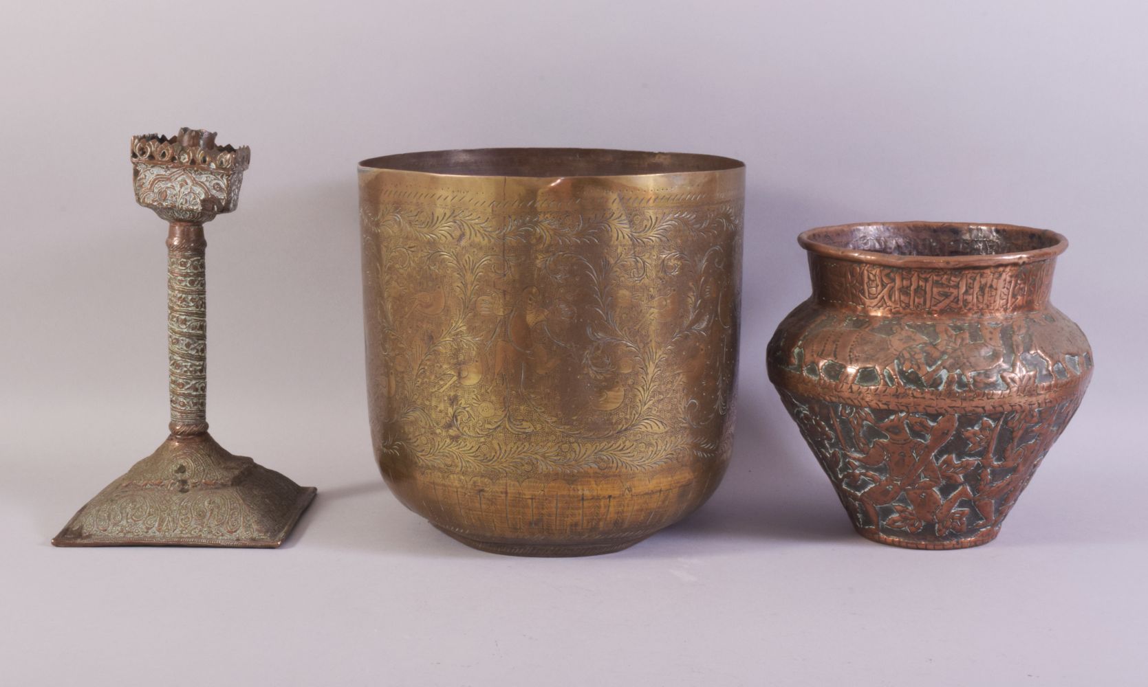 THREE ISLAMIC BRASS / METALWARE ITEMS, comprising a embossed and chased copper vase, an engraved