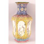 A CHINESE FAMILLE ROSE / FAMILLE JAUNE HEXAGONAL PORCELAIN VASE, painted with six oval panels