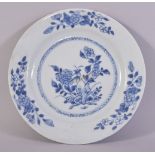 A CHINESE BLUE AND WHITE PORCELAIN DISH, painted with flowers, 23cm diameter.