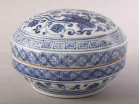 A CHINESE BLUE AND WHITE PORCELAIN CIRCULAR BOX AND COVER, the cover decorated with phoenix, lotus