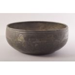 AN ISLAMIC MAMLUK ENGRAVED BRONZE BOWL, engraved with panels of calligraphy, 22.5cm diameter.